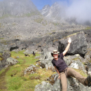 Jennie sits on a rock on a hiking trail in Hatchers Pass. 