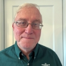 Head shot of man smiling and wearing a green USFWS uniform shirt.