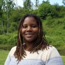 Fish Biologist, Nicole Hams, close up in front of a pond and trees