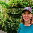 Headshot photo of Vona Kuczynska in front of moss covered karst taken by USFWS.