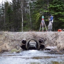 man surveying a culvert