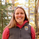 smiling woman in a USFWS vest