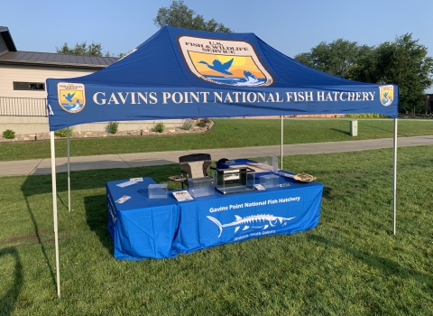 Pop up canopy shelter with several Fish and Wildlife Service logos.