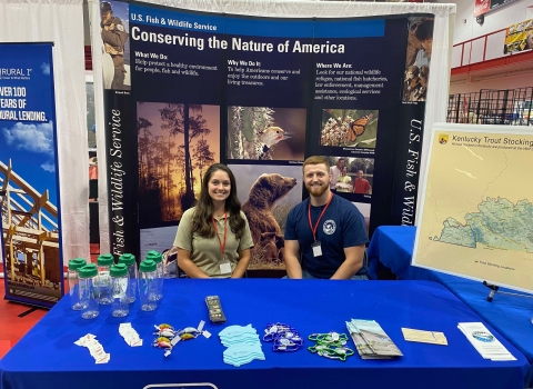 A USFWS employee and volunteer at an informational booth