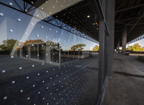 two inch dot pattern applied to windows along a large building