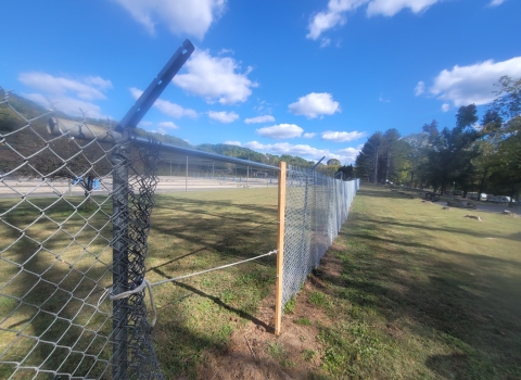 Stretching a 400 foot section of chain link fence with a puller fabricated by hatchery staff